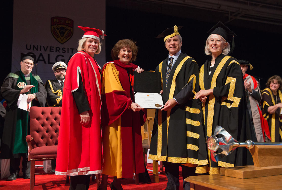 Her Honour, the Honourable Lois Mitchell, Lieutenant-Governor of Alberta, second from left, being conferred with UCalgary's honorary Doctor of Laws by President Elizabeth Cannon, Chancellor Robert Thirsk, and Board of Governors Chair Bonnie DuPont in 2015. 