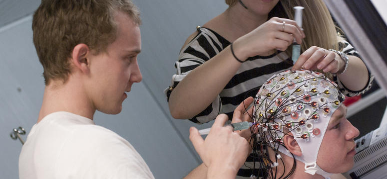 University of Calgary graduate student Hendrik Enders, left, did his PhD in biomechanics at the Faculty of Kinesiology. His research focused on understanding the brain’s role in how people initiate and control walking, or other motions, as part of a larger effort by his team to understand human movement. He is pictured here setting up an apparatus to monitor brain activity during exercise at the Human Performance Laboratory.