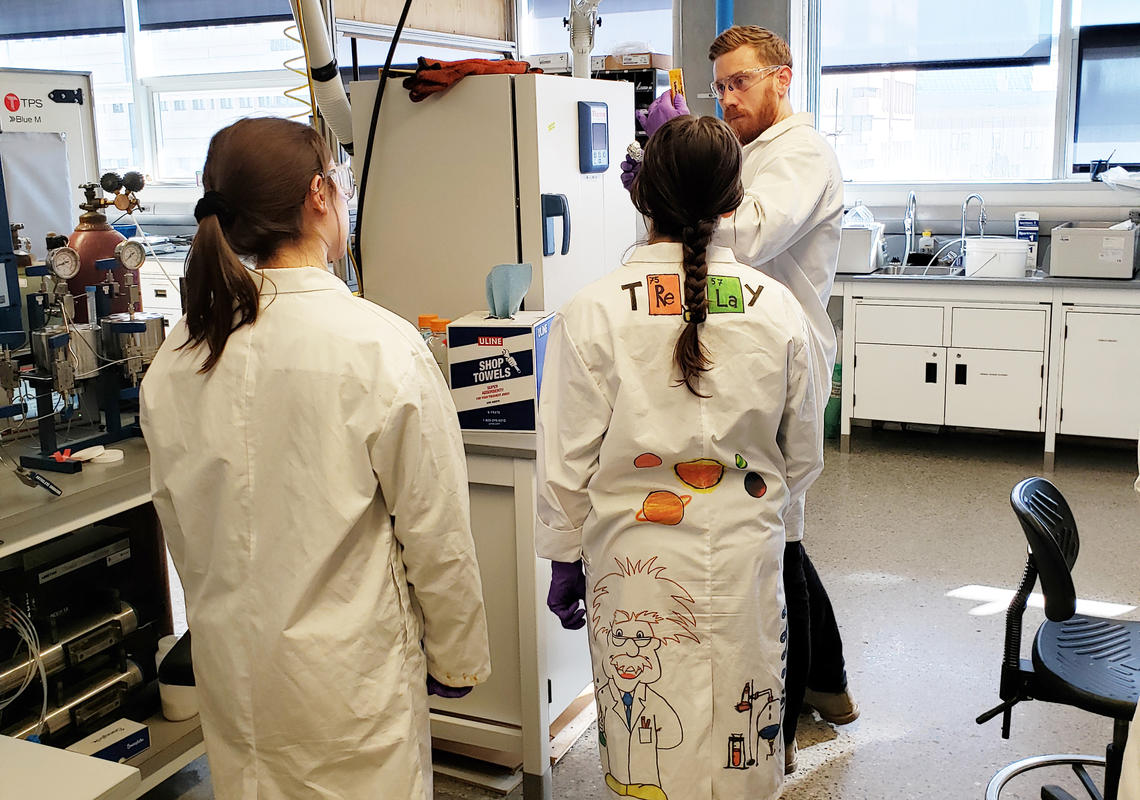 Robert Barnes works with students Gillian Alm and Jessica Tremblay.