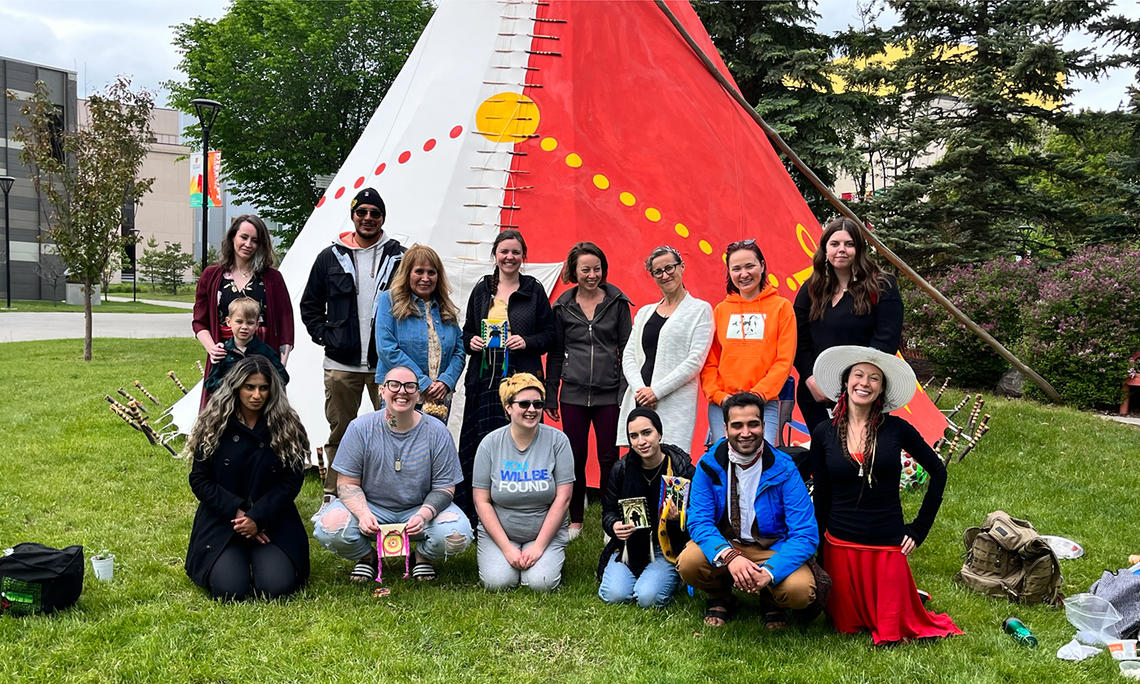class of students in front of tipi