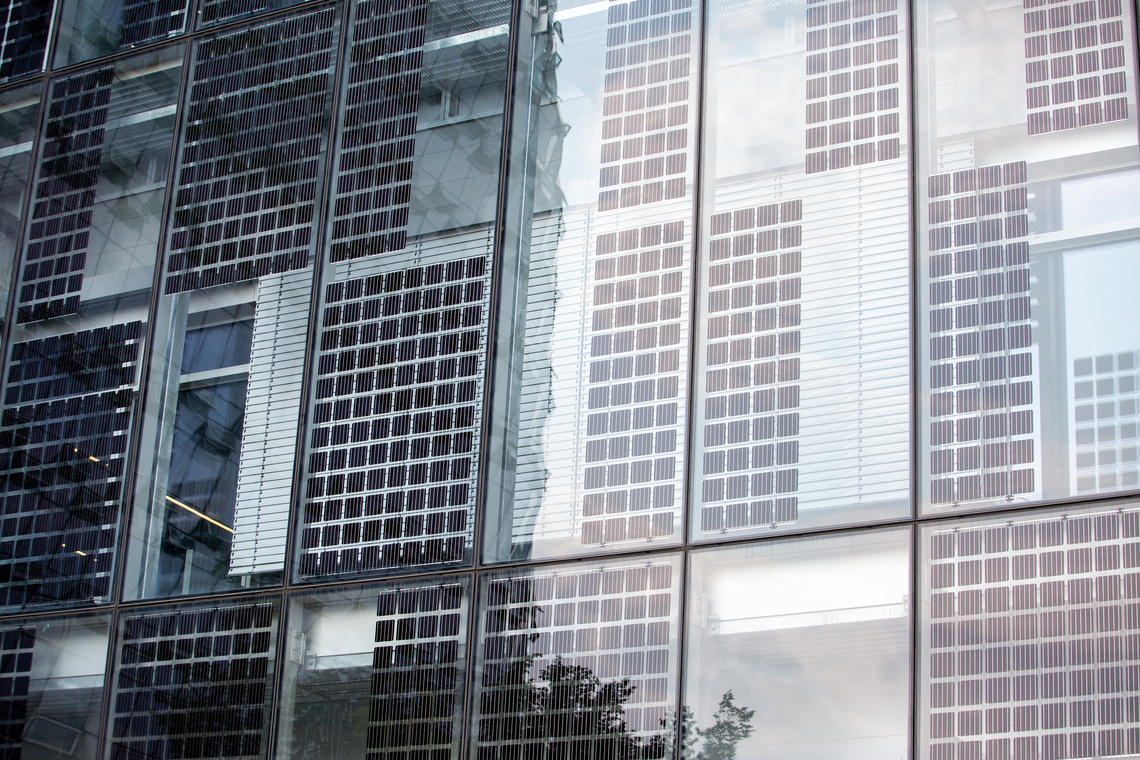 Vertical solar panels cover the glass of the corner of Hunter Student Commons that is calculated to get the most sunlight each day.