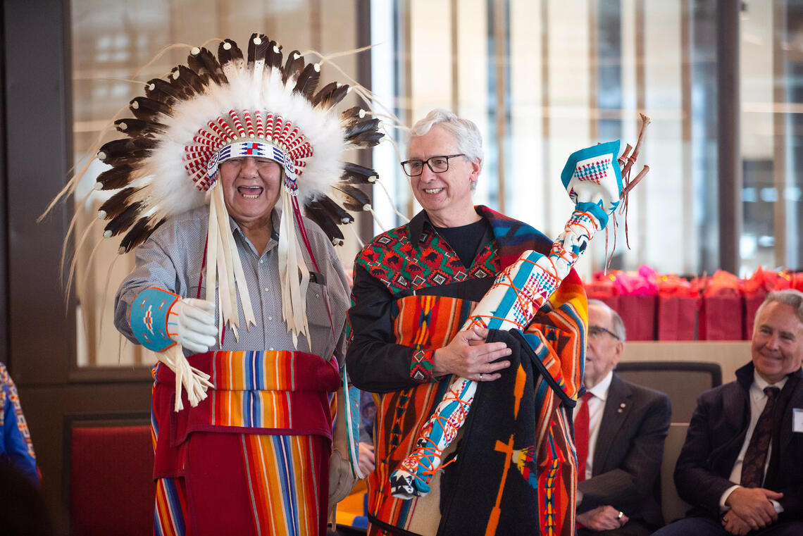 Jim Dewald, Dean of Haskayne, presented with a Big Medicine Blanket during the ceremony