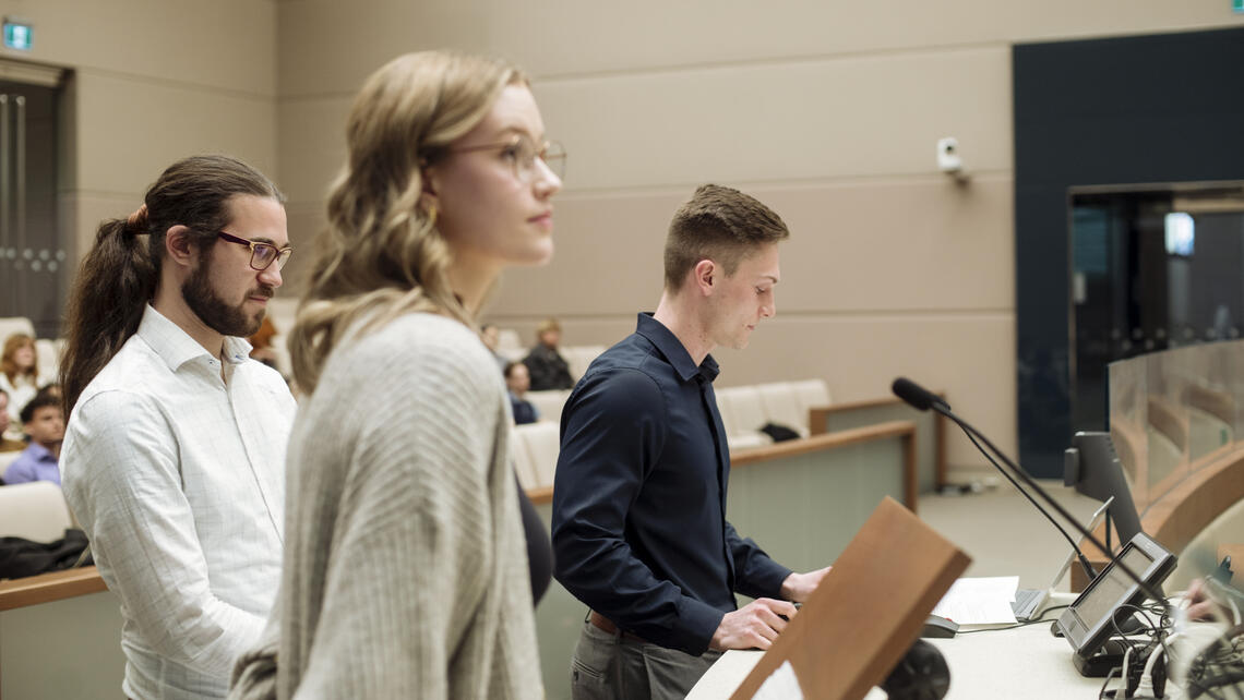 Students Mikhail Storozhakov, Farrah Cormier and Dylan Dallaire presenting at city hall.