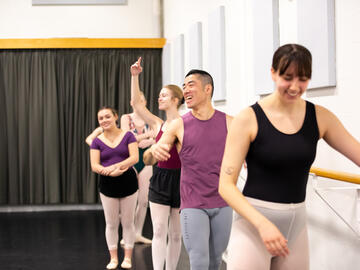A group dances at the barre