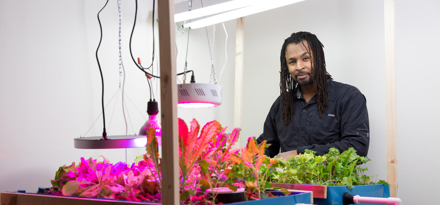 Tatenda Mambo, postdoctoral associate, Sustainability Studies, displays his aquaponics research. Photo by Riley Brandt, University of Calgary