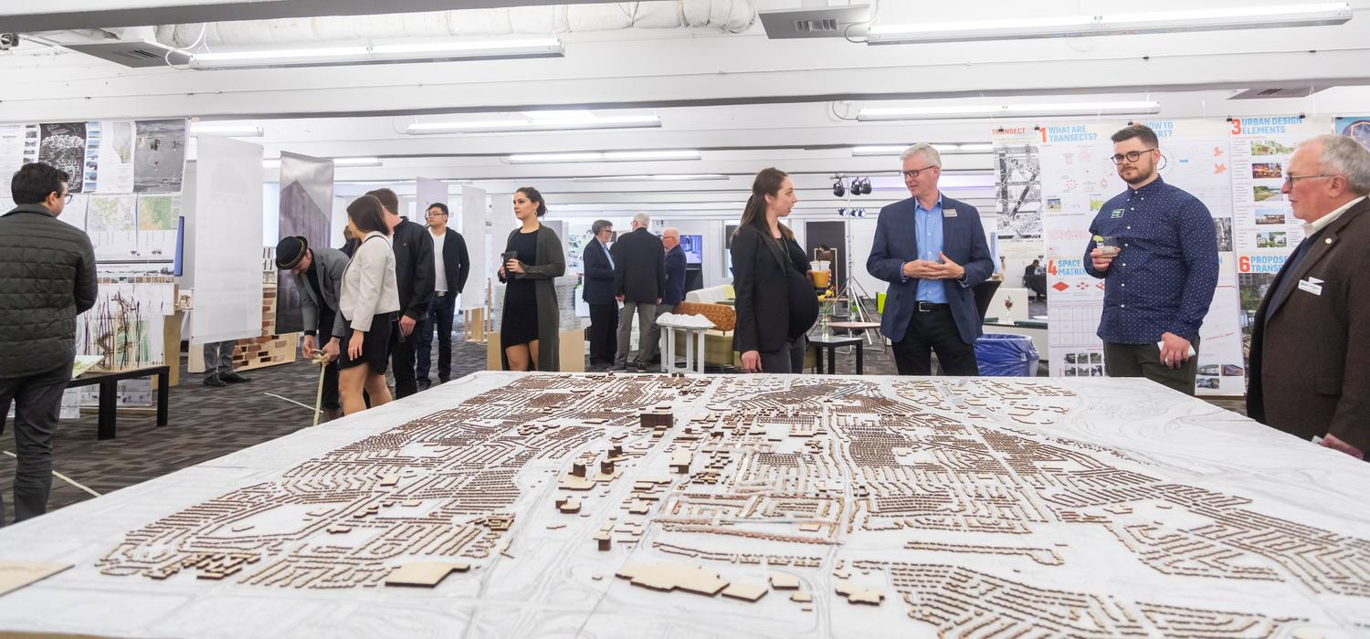 Robyn Erhardt, centre, shares a thought with instructor Douglas Leighton at the School of Architecture, Planning and Landscape Year-End Show 2019. Photo by Neil Zeller, for the School of Architecture, Planning and Landscape