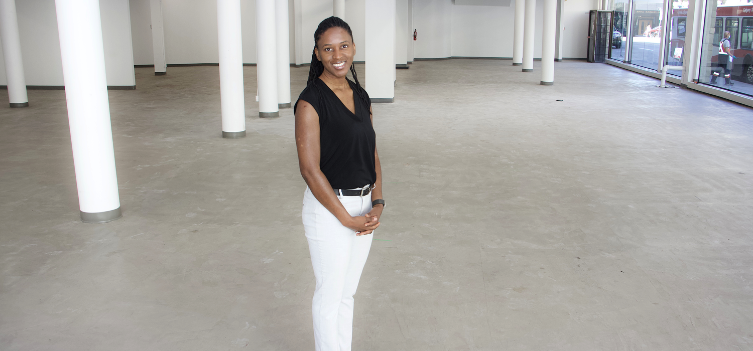 Faculty of Social Work professor Patrina Duhaney stands in an empty storefront which will be converted into a space for the Black Youth Summer Leadership program.