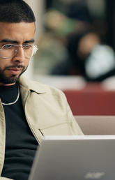 Haskayne Master of Management student works on his laptop at Scurfield Hall