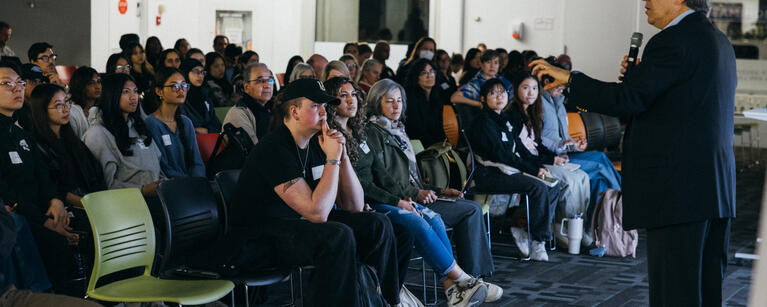 A Design Matters audience watching a lecturer speak.