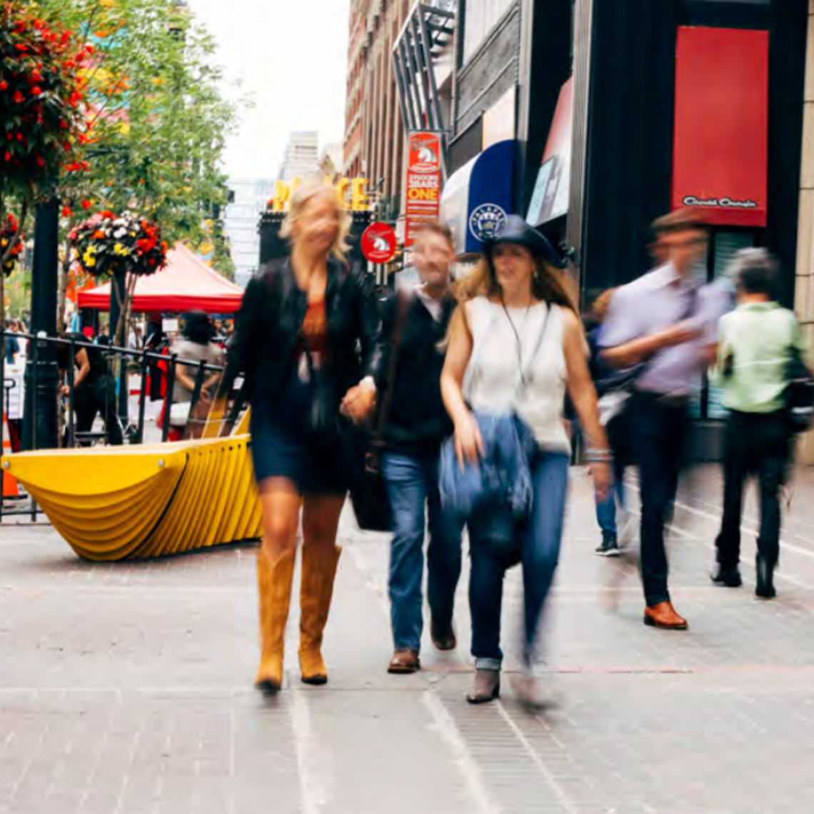 People walking down a lively downtown street (Stephen Avenue, Calgary).