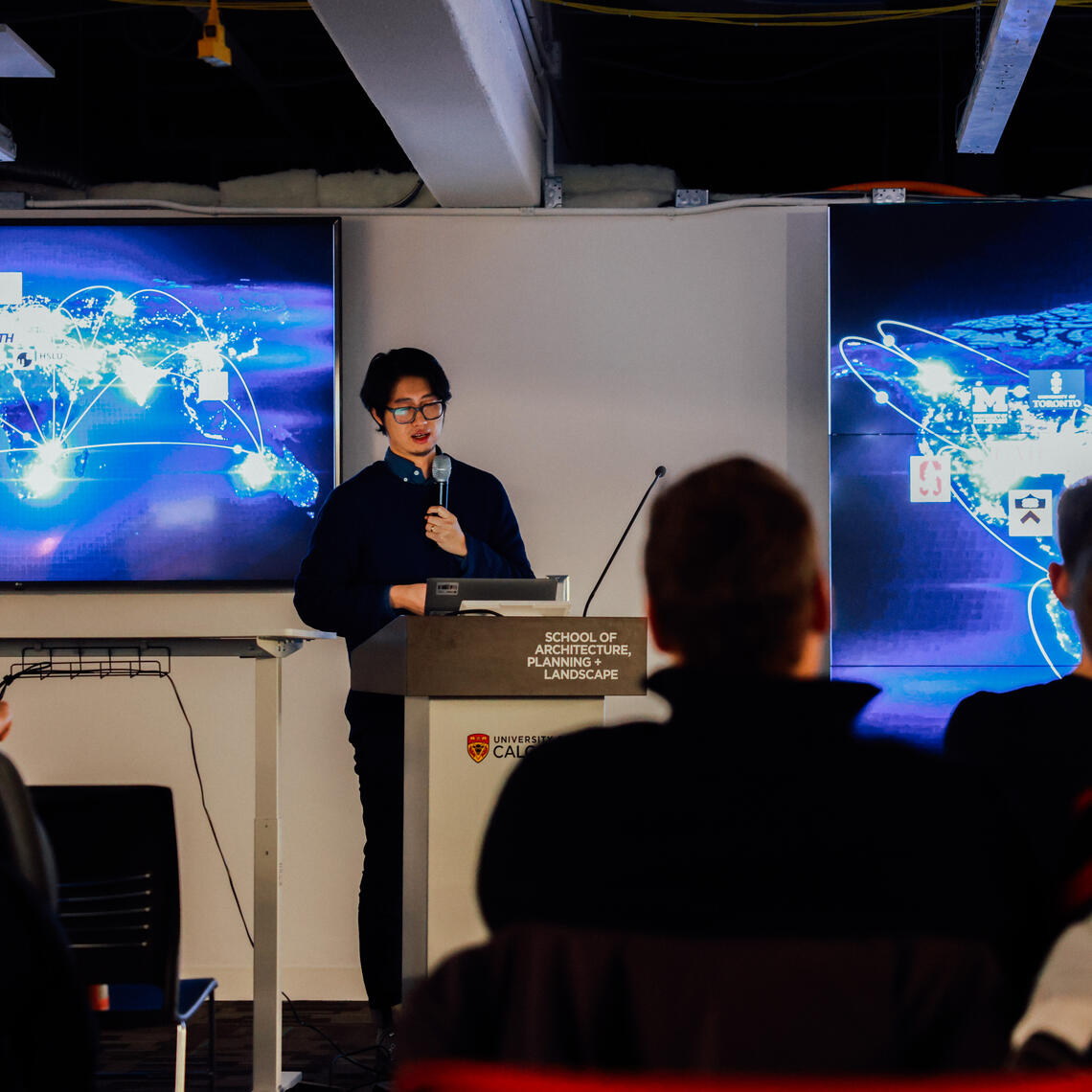 Peter Vestras and Li Chen presenting in the CBDL building.
