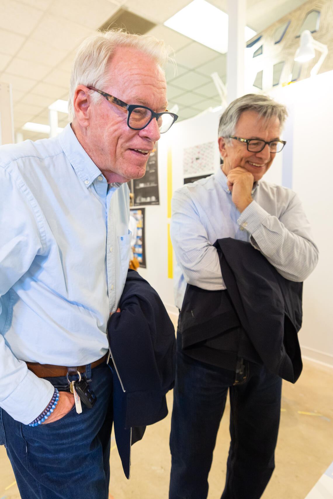two men take a look at an architectural model with curiosity