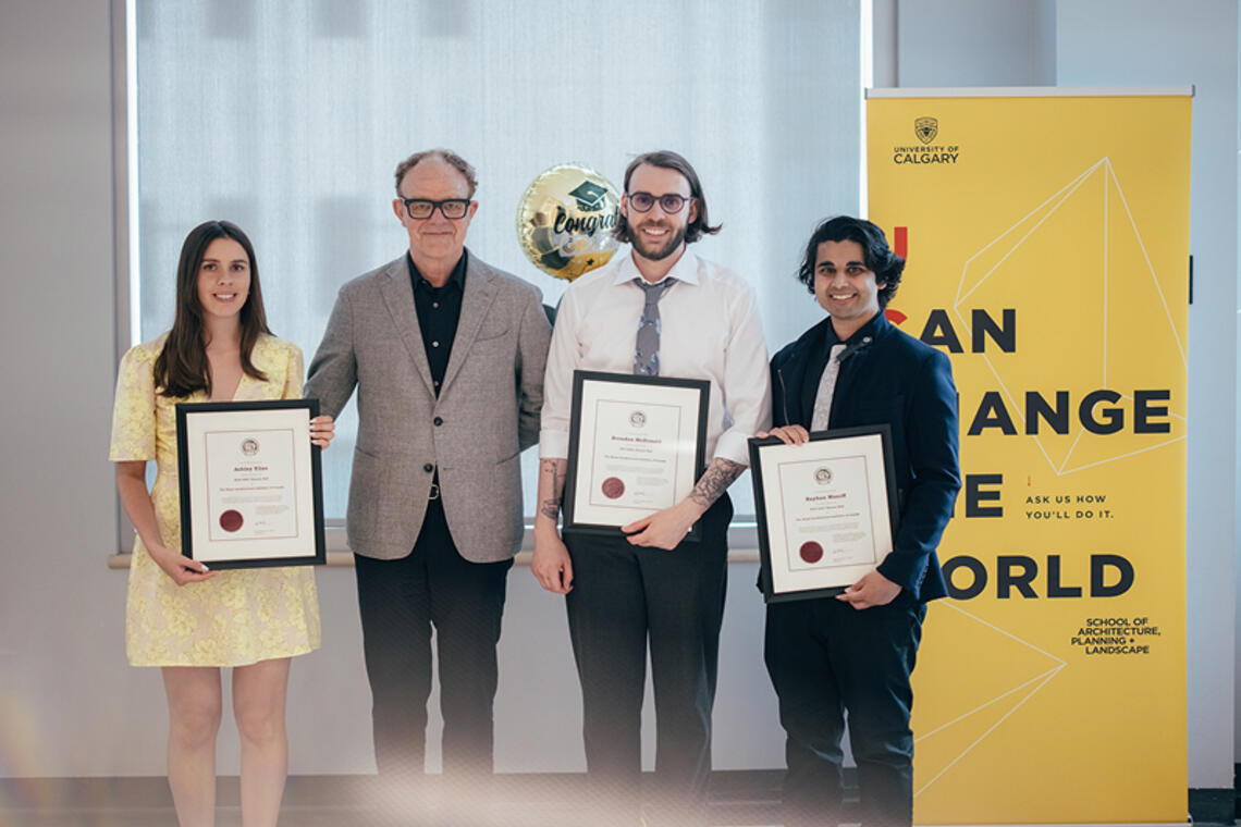 Three SAPL graduates pose with the Dean of the school after receiving honour awards.