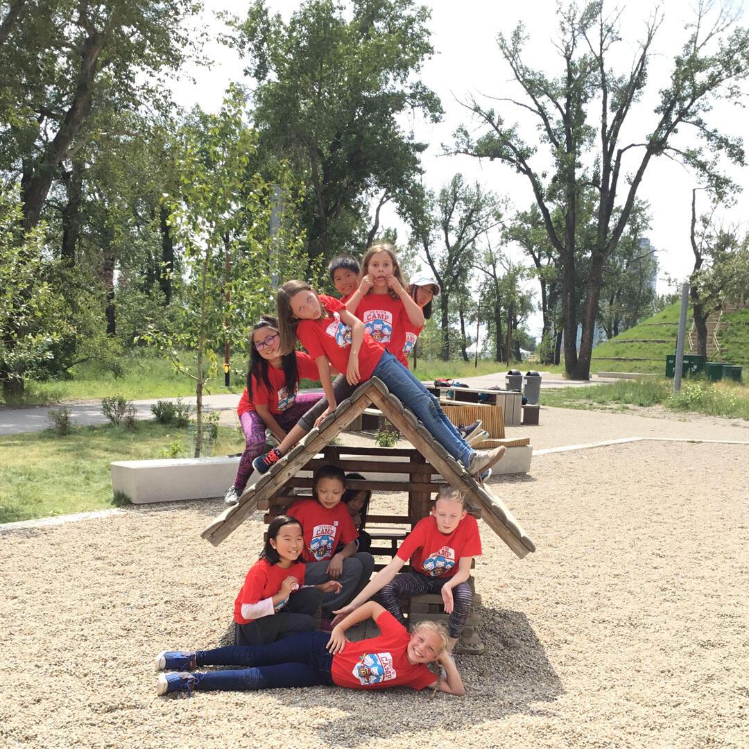 Children attending Design Camp smile to the camera at St. Patrick's Island Park