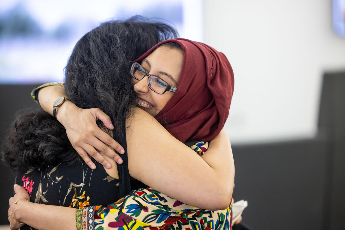 Students hug each other