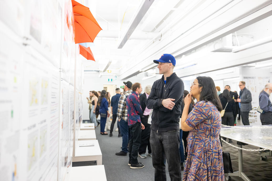 SAPL students stare at student work in a wall